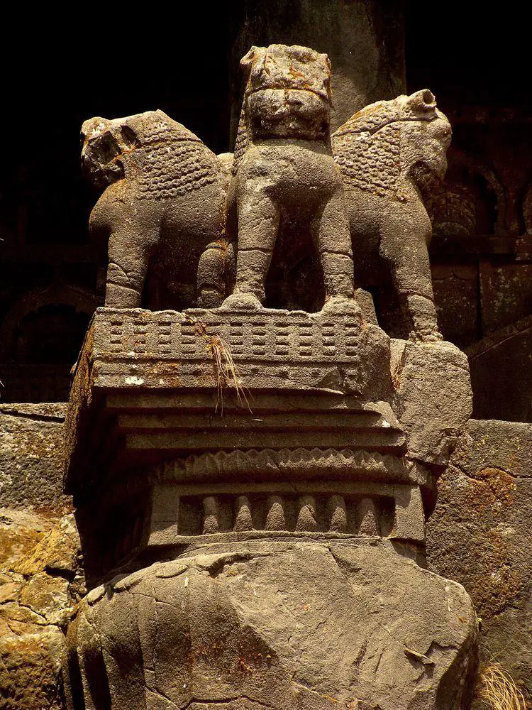 Karla Caves in India, lion sculptures in top of pillar in front of chaitya