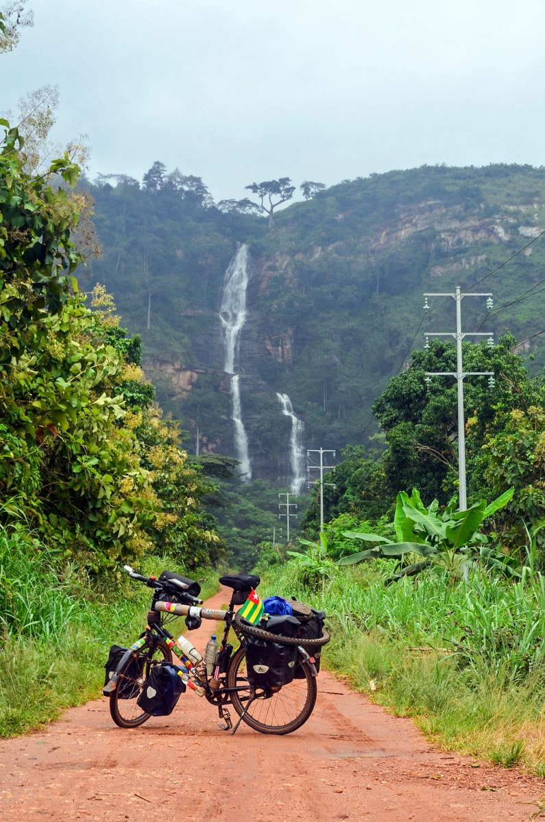 Kpalimé Falls with the bike of globetrotter Jean-Baptiste Dodane in the front, Togo