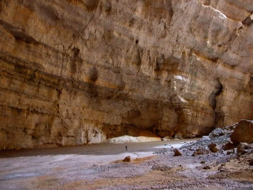 Caver walking inside the Majlis al Jinn cave (Oman)