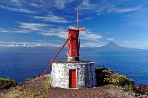 Traditional windmill in São Jorge (Azores) with Mount Pico in the background