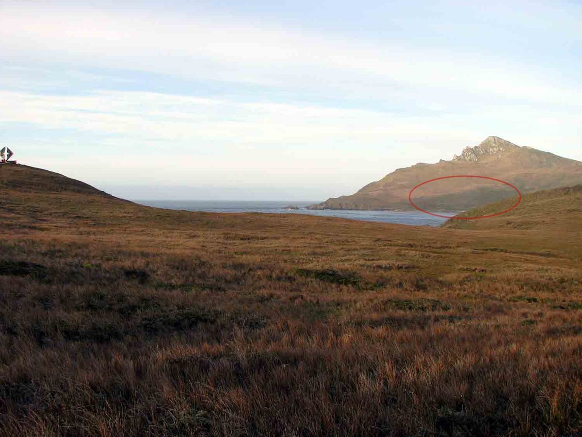 Hornos Island with the southernmost forest. Monument of the Cape of Horn is seen in the left side.