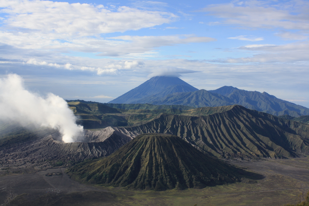 Mount Bromo with a white plume and Mount Batok in the forefront